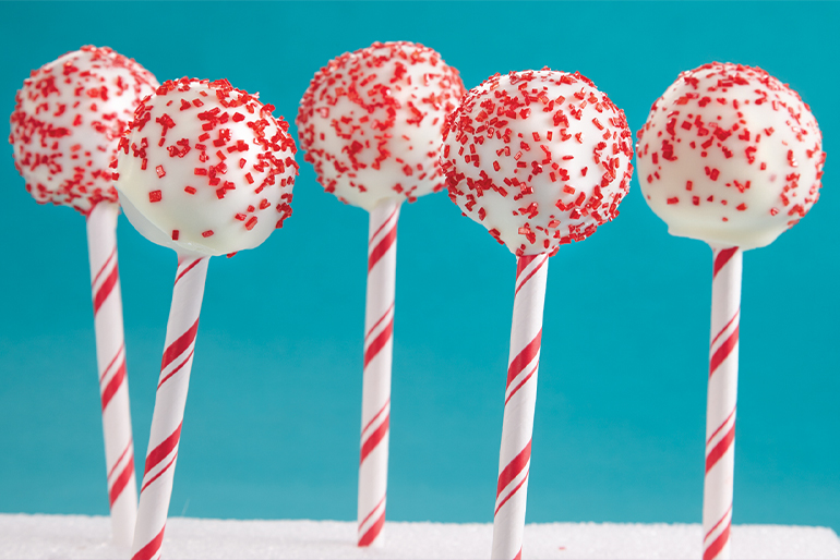 Red Velvet cake pops covered with white chocolate and red sprinkles