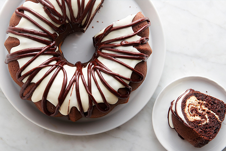 Chocolate cake decorated with white icing and chocolate frosting