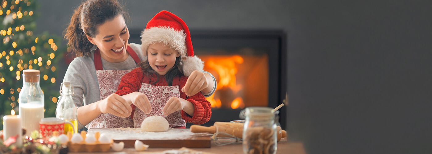 mother-daughter enjoying baking with Christmas theme